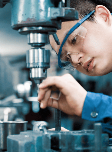 industrial machinist completing a machining job